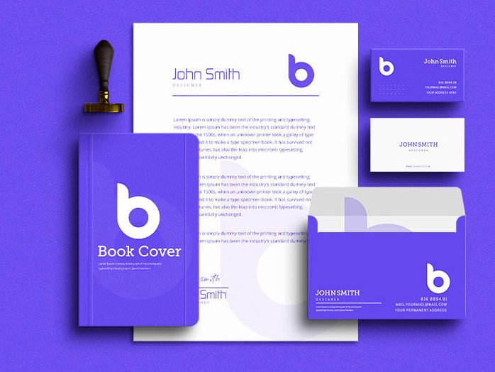 A mockup of small business branding collateral, with branded notebooks, letterheads, envelopes and business cards.