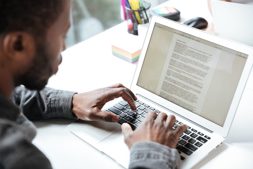 man writing conversational contnet on laptop - Digital Marketing Agency