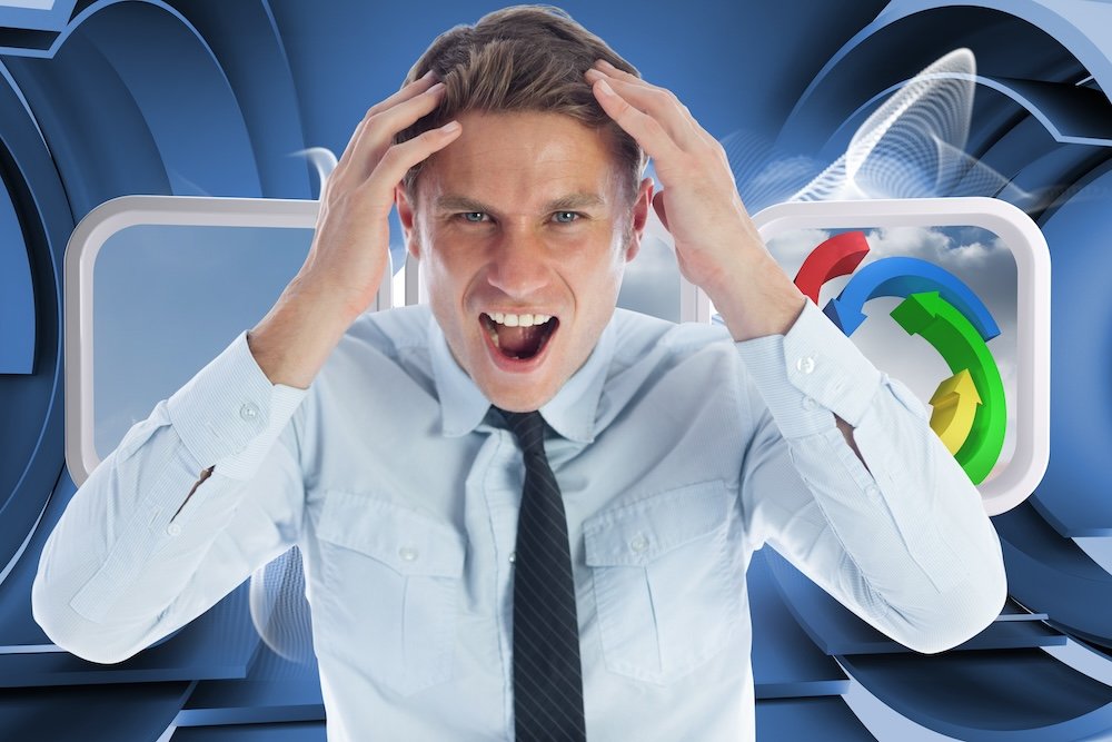 A stressed businessman shouting and holding his head, while standing against an abstract linear blue background.