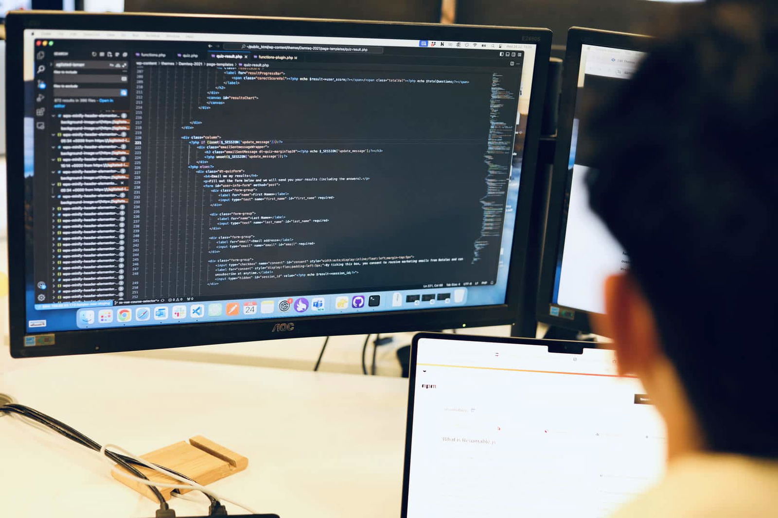 An SEO specialist looking at a computer monitor while working on technical optimisation within a website's code.