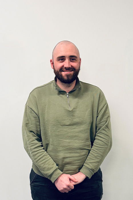 Joe Sherin, one of Damteq's PPC Executives, standing in front of a white wall, smiling at the camera.